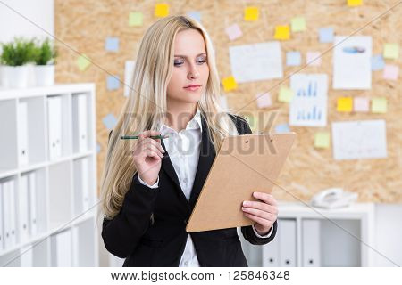 Businesswoman Writing In Office