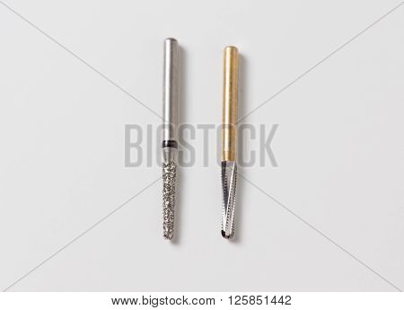 dental turbine handpiece with burs on a white background