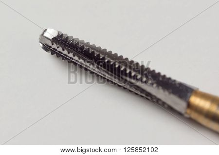 dental turbine handpiece with burs on a white background