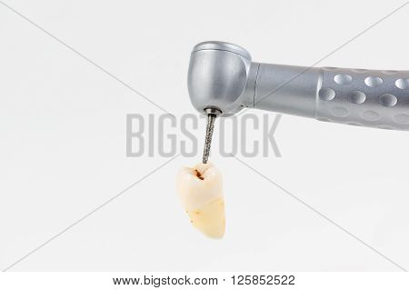 dentist using dental turbine handpiece for dental treatment