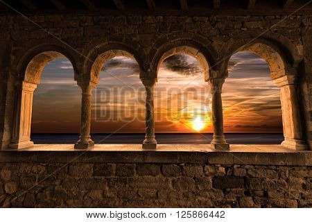 Sunset over the sea with cloudy sky. Church of San Pietro (1198) in Portovenere (UNESCO world heritage site) - La Spezia Liguria Italy