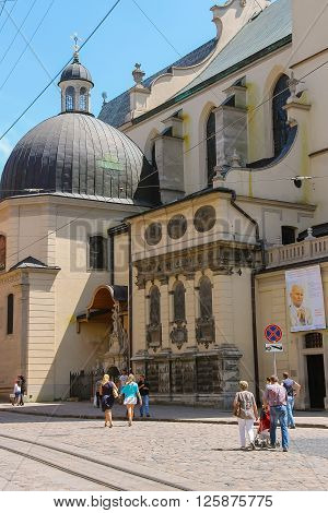 Lviv Ukraine - July 5 2014: People walking near Latin Cathedral (Archcathedral Basilica of the Assumption of the Blessed Virgin Mary)