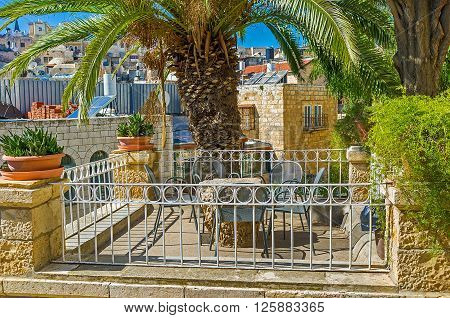 The scenic terrace opposite the city roofs is the best place to enjoy the noisy Muslim Quarter from the top Jerusalem Israel.