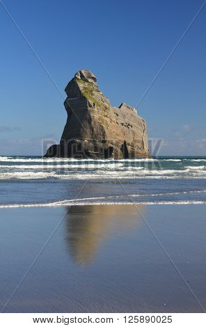 Island at Wharariki Beach New Zealand. Rock formation at the West Coast of the South Island. Famous tourist attraction.