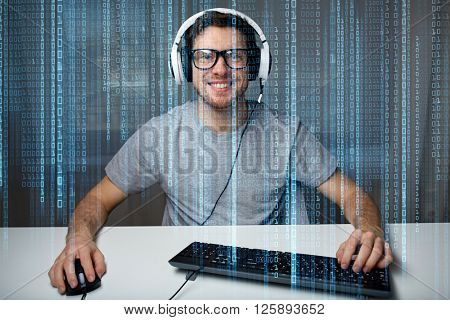 technology, gaming, entertainment, let's play and people concept - happy smiling young man in eyeglasses with headset playing computer game at home and streaming playthrough or walkthrough video