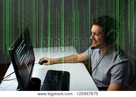 technology, gaming, entertainment, let's play and people concept - happy young man in headset with pc computer playing game at home and streaming playthrough or walkthrough video