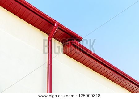 Red Rain Gutter System On Rooftop