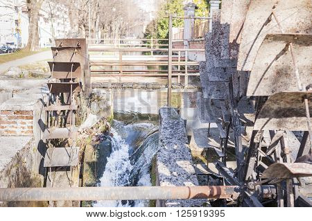 Old iron wheel a watermill. Ruins of a watermill.