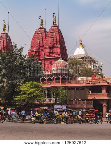 DELHI INDIA - 19TH MARCH 2016: A view of streets and the Shri Digambar Jain Lal Mandir Temple in Delhi. Lots of Rickshaws and people can be seen.