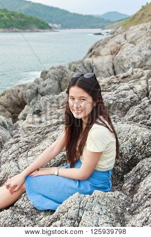 Girl at reef on background of the bay Puket in Thailand