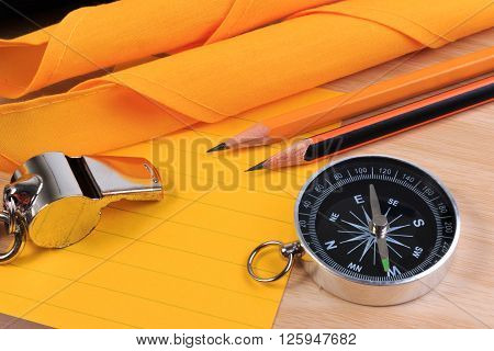 Orderliness White Scout Rope, Scarf, Whistle, Compass, Pencil And Paper Note On Wooden Table.