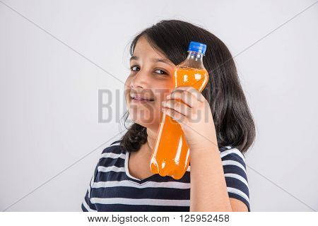 indian girl with cold drink bottle, asian girl drinking cold drink in pet bottle, girl kid and cold drink, indian cute girl drinking mango juice or orange juice in plastic bottle