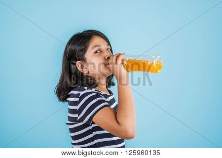 indian girl with cold drink bottle, asian girl drinking cold drink in pet bottle, girl kid and cold drink, indian cute girl drinking mango juice or orange juice in plastic bottle