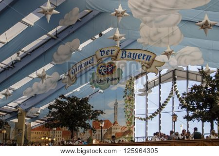 MUNICH, GERMANY - OCTOBER 02, 2015: Inside the Hacker Festzelt (Himmel der Bayern) at Oktoberfest with its lovely decoration of the roof and the surrounding walls
