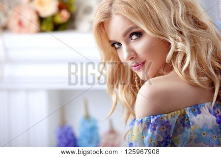 beautiful girl model woman portrait professional makiyad and hair in a flower dress on a floral background bright tone pink lips blonde hair blonde curls sound around very cute and beautiful.