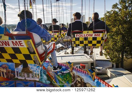 MUNICH, GERMANY - OCTOBER 02, 2015: Carousel in motion with people flying through the air on Theresienwiese