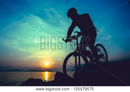 Healthy Lifestyle. Silhouette Of Bicyclist Riding The Bike At Seaside. Outdoors.