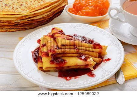 Pancakes with jam and cup of tea.