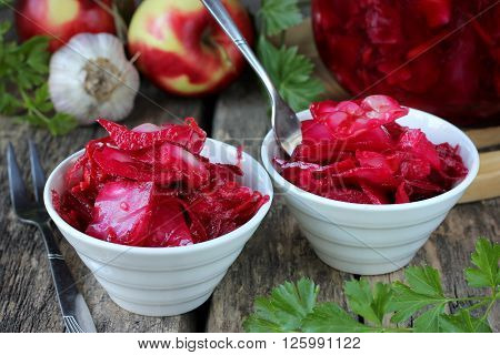 Sauerkraut with beets and garlic on a wooden table
