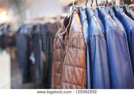 Collection of leather jackets on hangers in the shop.