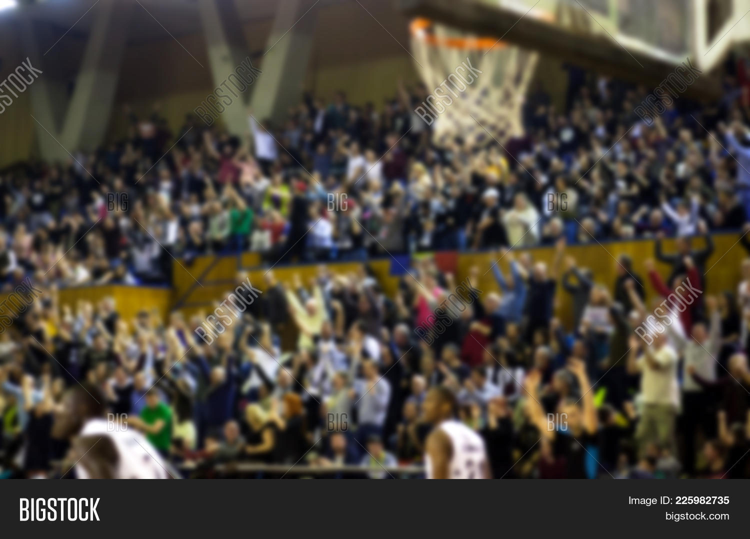 blurred basketball crowd watching game in arena Stock Photo