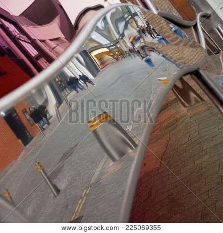 UK street reflected in purple and clear mirrors. Square format.