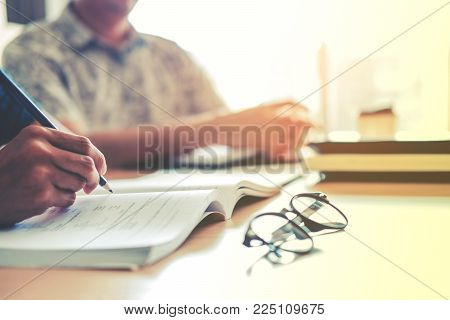 University Students Using Laptop Meeting For Research Homework In College