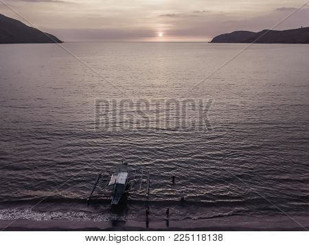 Drone view of pinky sunset in cove with wood Philippines boat