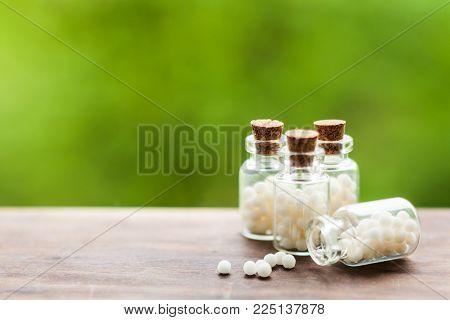 Classical Homeopathy globules in vintage bottles and nature leaves
