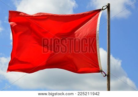 Lifeguard station red warning flag on the ocean beach