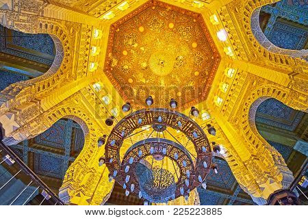 ALEXANDRIA, EGYPT - DECEMBER 17, 2017: The scenic cupola of Abu al-Abbas al-Mursi Mosque with stone arches from the sides and carved wooden decor in the middle, on December 17 in Alexandria.