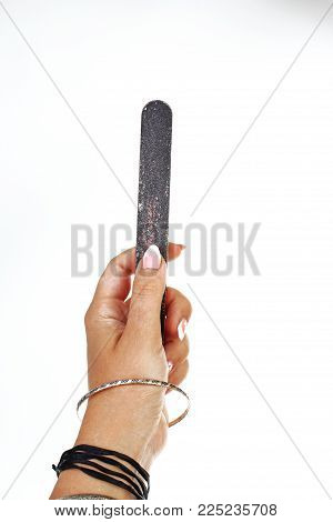 Woman hand holding nail filer on isolated white cutout background. Studio photo with studio lighting easy to use for every concept..
