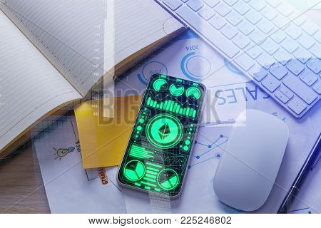 Top view of office desktop with ethereum smartphone app, fiancial report and other items on city background. Cryptocurrency and future concept. Double exposure