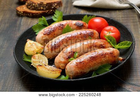 Barbecue sausages in frying pan, close up view