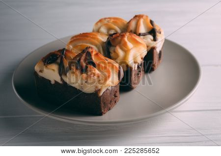 curd cake in a plate lies on a wooden background