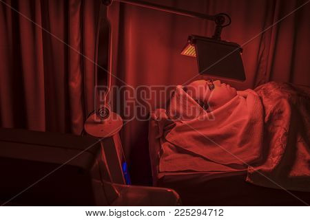 a facial face by photodynamic therapy in clinic.