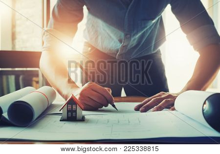 Focus House Model, Architect Design Concept. Young Engineer Drawing Of House Structure On Blueprint 