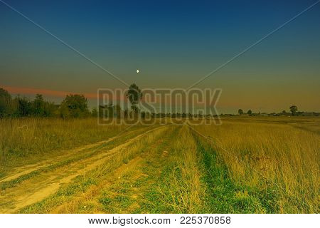 evening summer road country yellow grass lena city in the distance