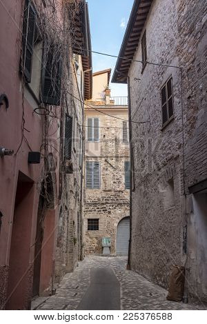 Historic buildings of Foligno, Perugia, Umbria, Italy: typical old street in the medieval quarter at evening