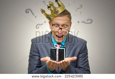 Winner. Award Ceremony. First Place Man. Surprised Man In Suit And Glasses With Golden Crown Above H