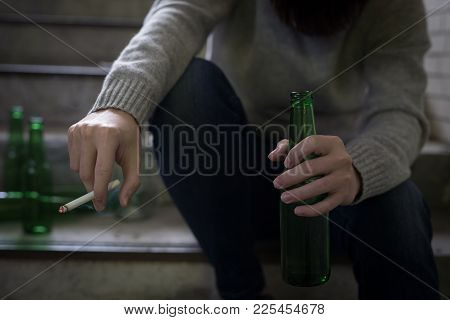 Depressed Man Sit In Underground Road With Beer And Cigarette
