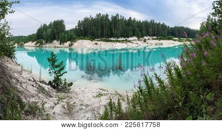 Old Flooded Clay Quarry With Surreal Vivid Blue Water And White Clay