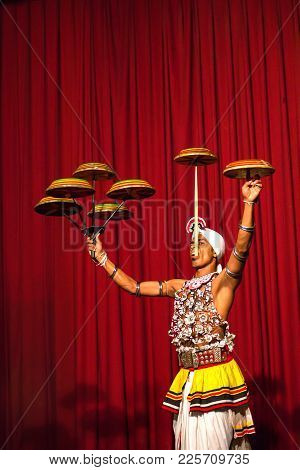 Kandy, Sri Lanka - Circa December 2013: Unidentified Man In Traditional Clothing Performes Plate-spi