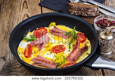 Breakfast For The Family. Omelette With Sausages. Studio Photo