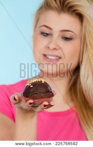 Diet, Sweets, Food Concept. Woman Holding Delicious Chocolate Cupcake With Peanut Frosting About To 