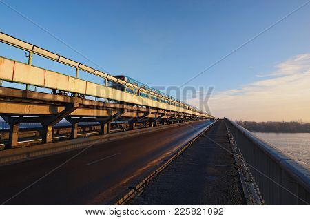 Metro Train Are Moving Along The Bridge. View To The Metro (subway) Bridge Over The Dnipro River In 