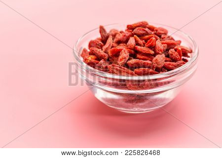 a small, glass bowl of dried red Tibetan goji berries (wolfberry) - superfruit