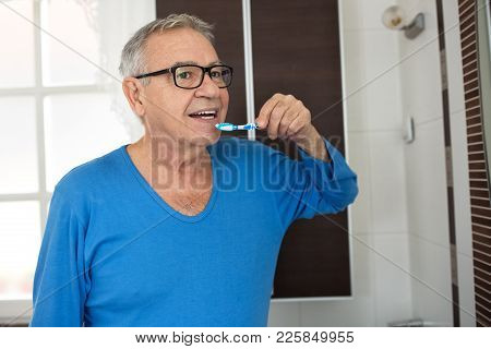 Senior Man Cleaning Teeth With Toothbrush