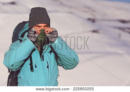 Man, Covering His Face With A Scarf, Wearing Grey Hat And Blue Anorak, Doing Outdoor Activity In Win