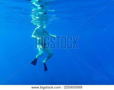 Akaba, Jordan - December 25, 2017: Swimmer Under Clear Blue Water While Snorkeling